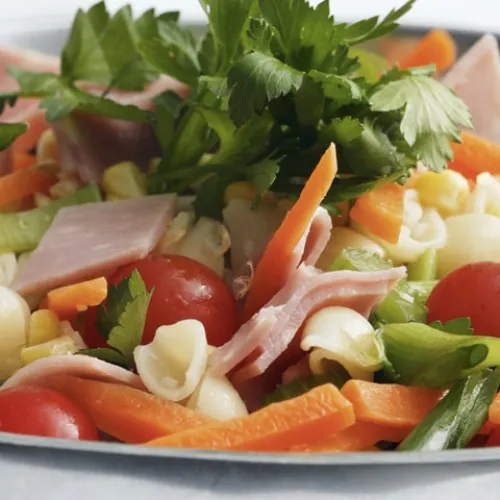Pasta salad with ham, avocado and tomatoes