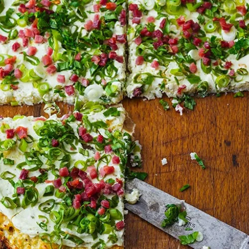 Cauliflower pizza with speck and cheese